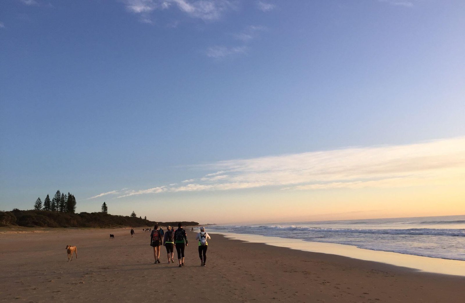 women walking up the beach