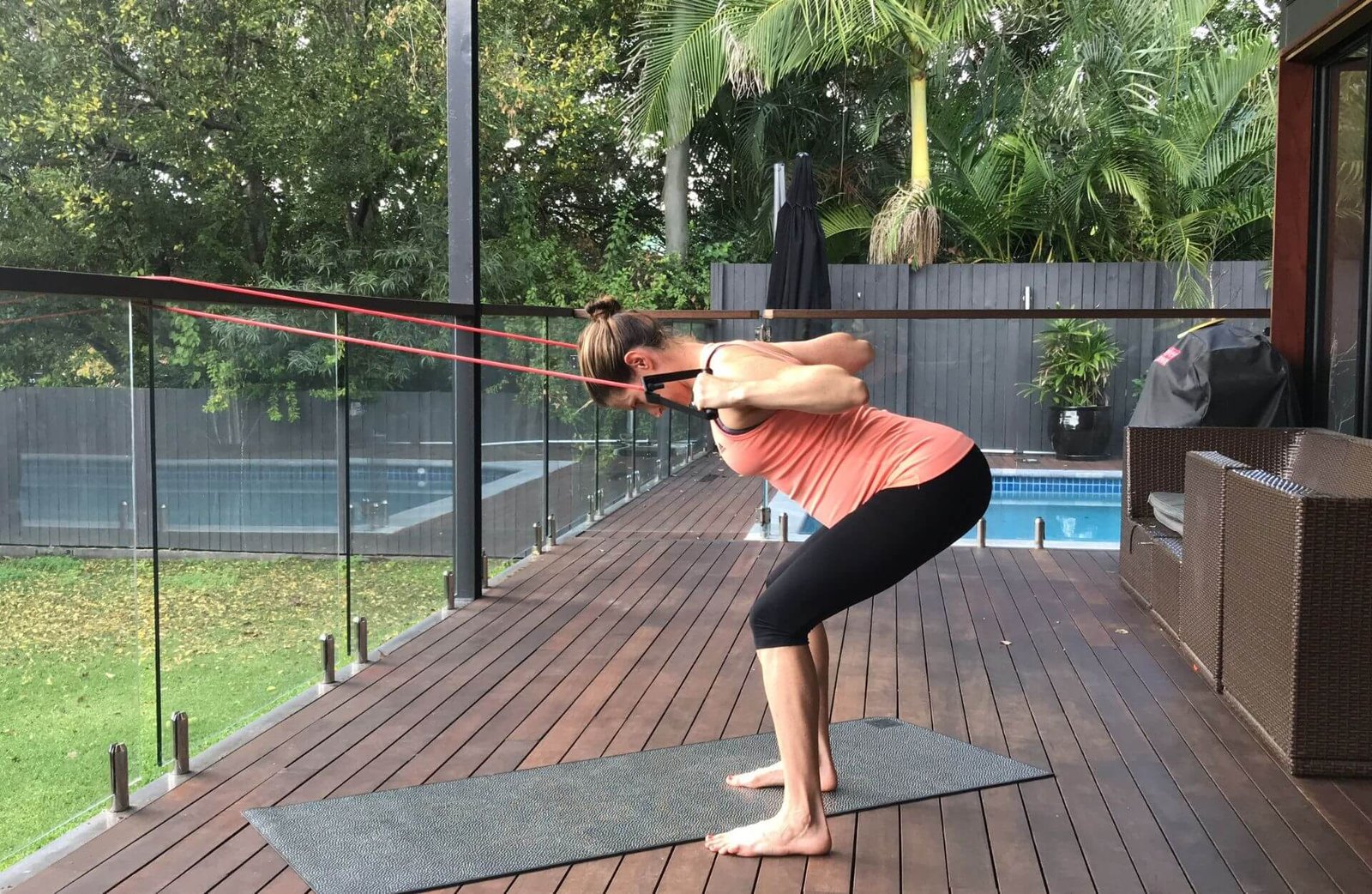 Em pregnant doing upper body exercise on outside deck