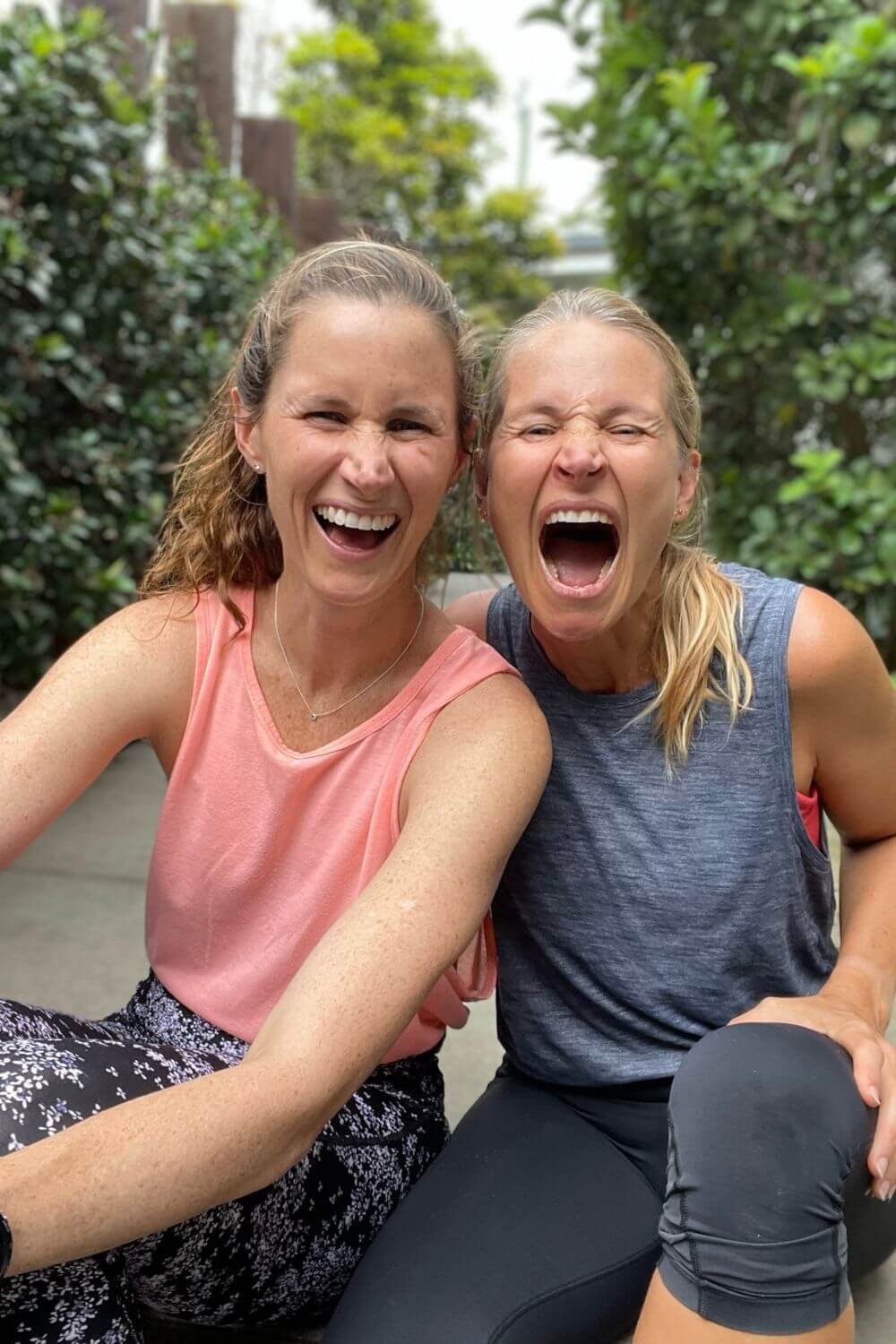 Anna and Em seated laughing