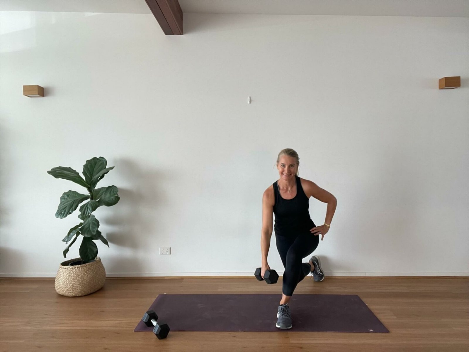 Anna in studio doing curtsey lunge