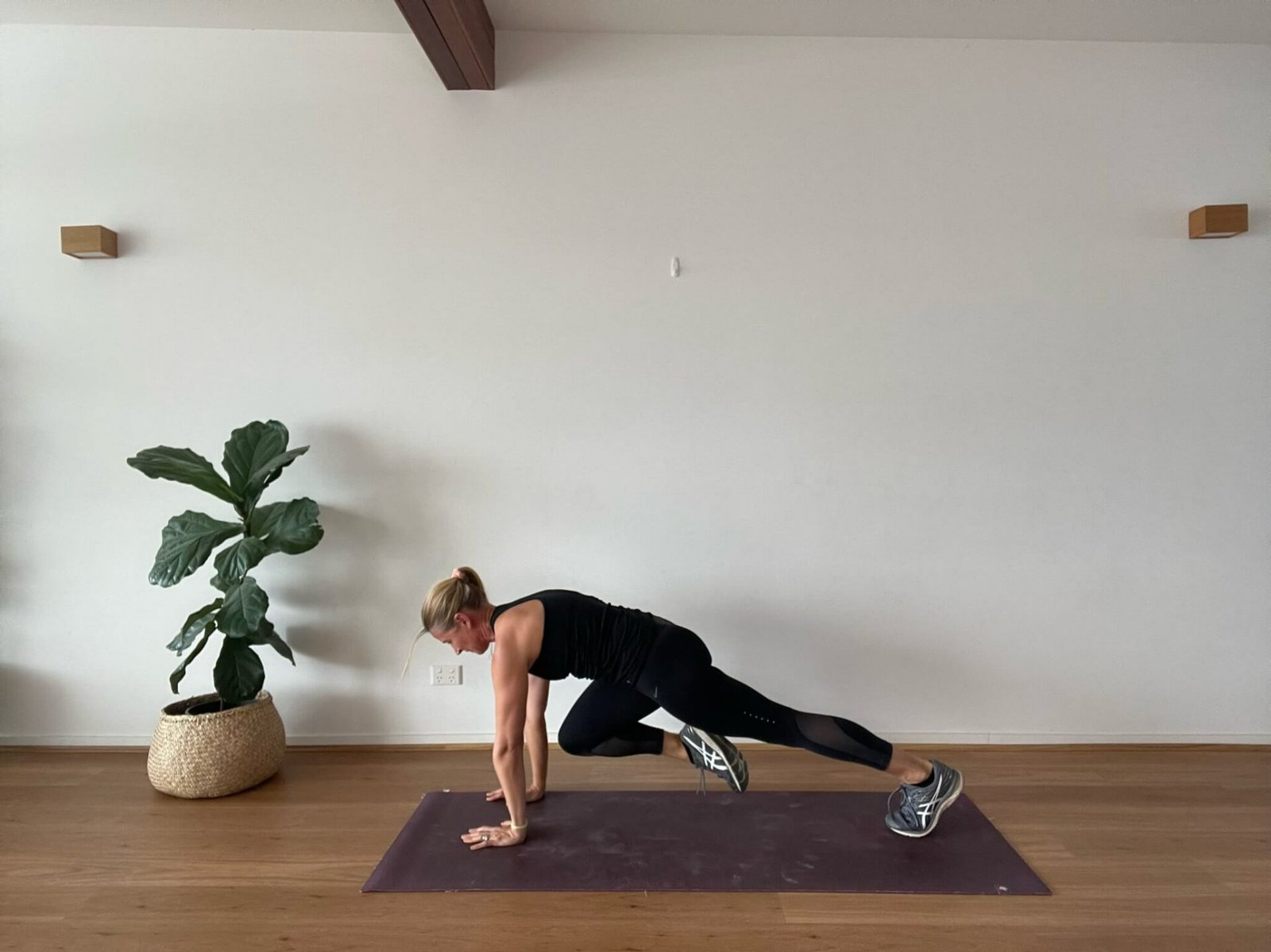 Anna in studio doing high plank knee tuck